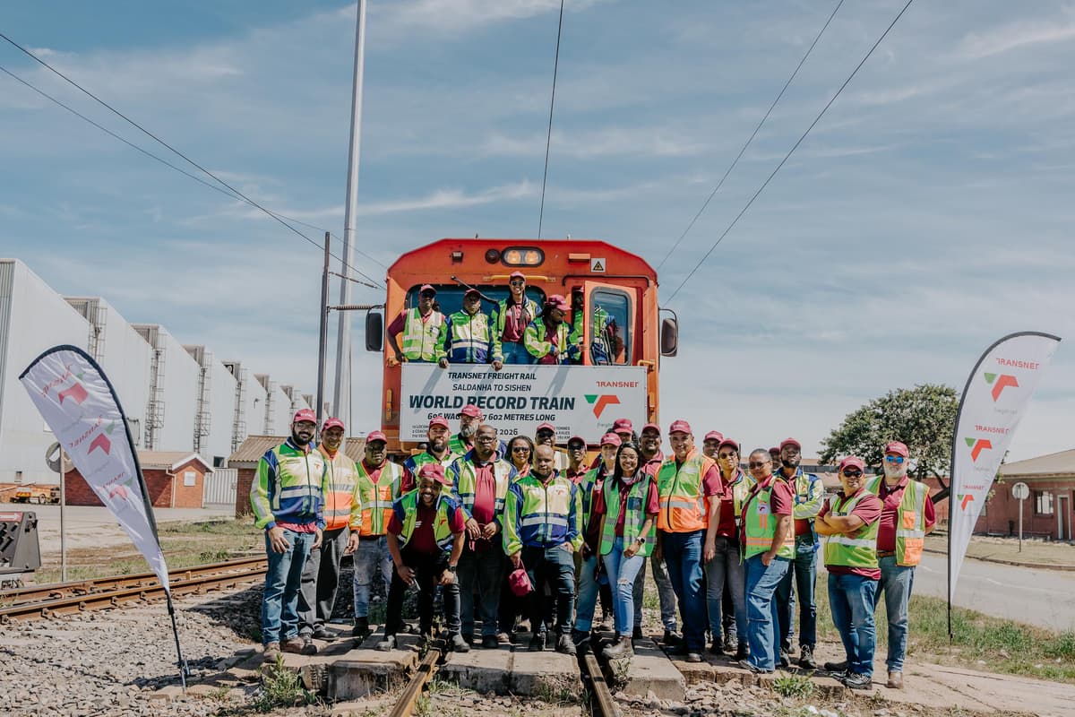 Transnet Freight Rail staff gatherat the lead locomotive of the record train.